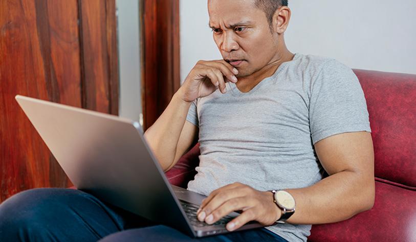 Claims management companies case study Image of a man working on his laptop