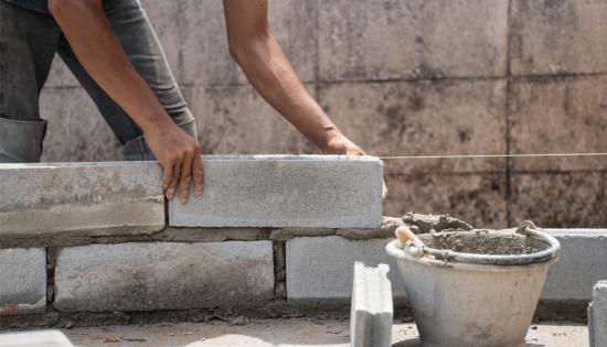 Cryptoasset authorisation blog image A construction worker builds a wall with concrete and mortar